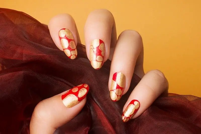 Artsy Red Nails With Gold Flakes