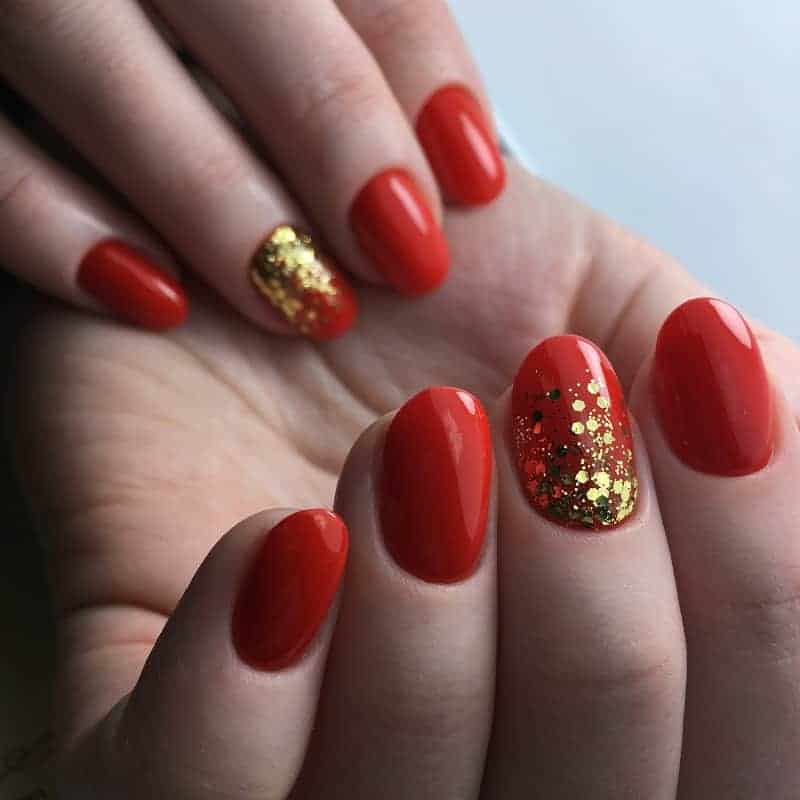 Short And Natural Red Nails With Gold Glitter