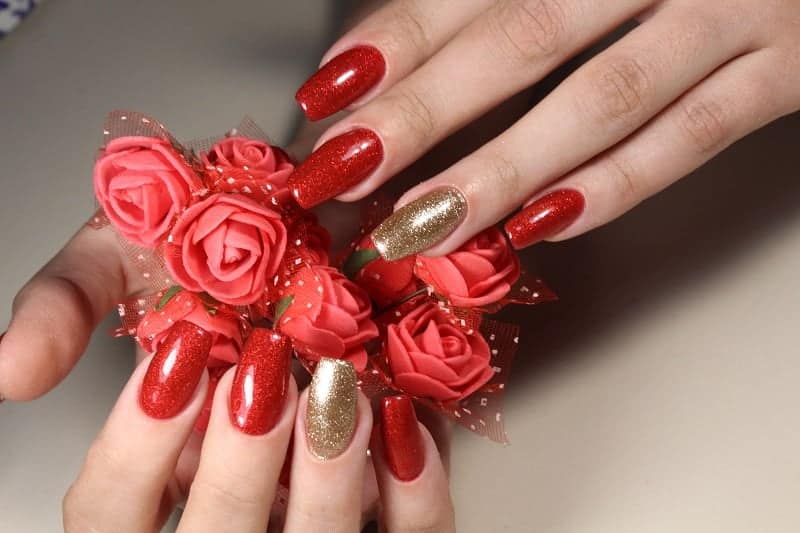 Square Shaped Red Nails With A Hue Of Gold On Ring Fingers