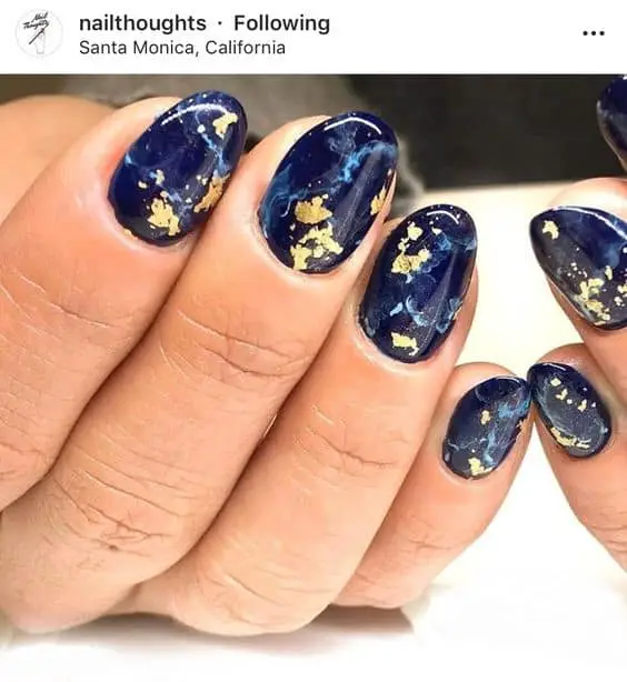 Oval Shaped Navy Blue Manicure With Golden Leaf Details