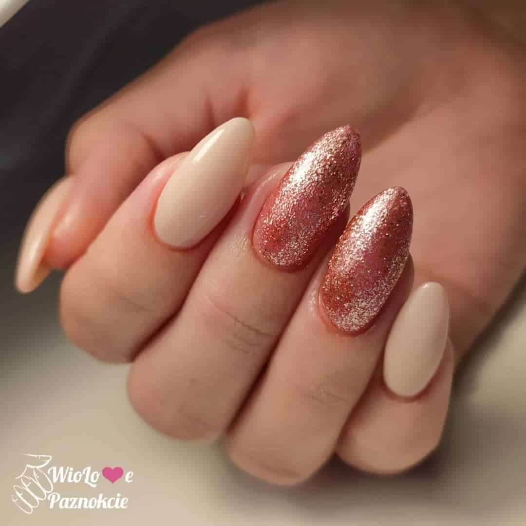 Oval Shaped Nude Nails With Red Glitter Details