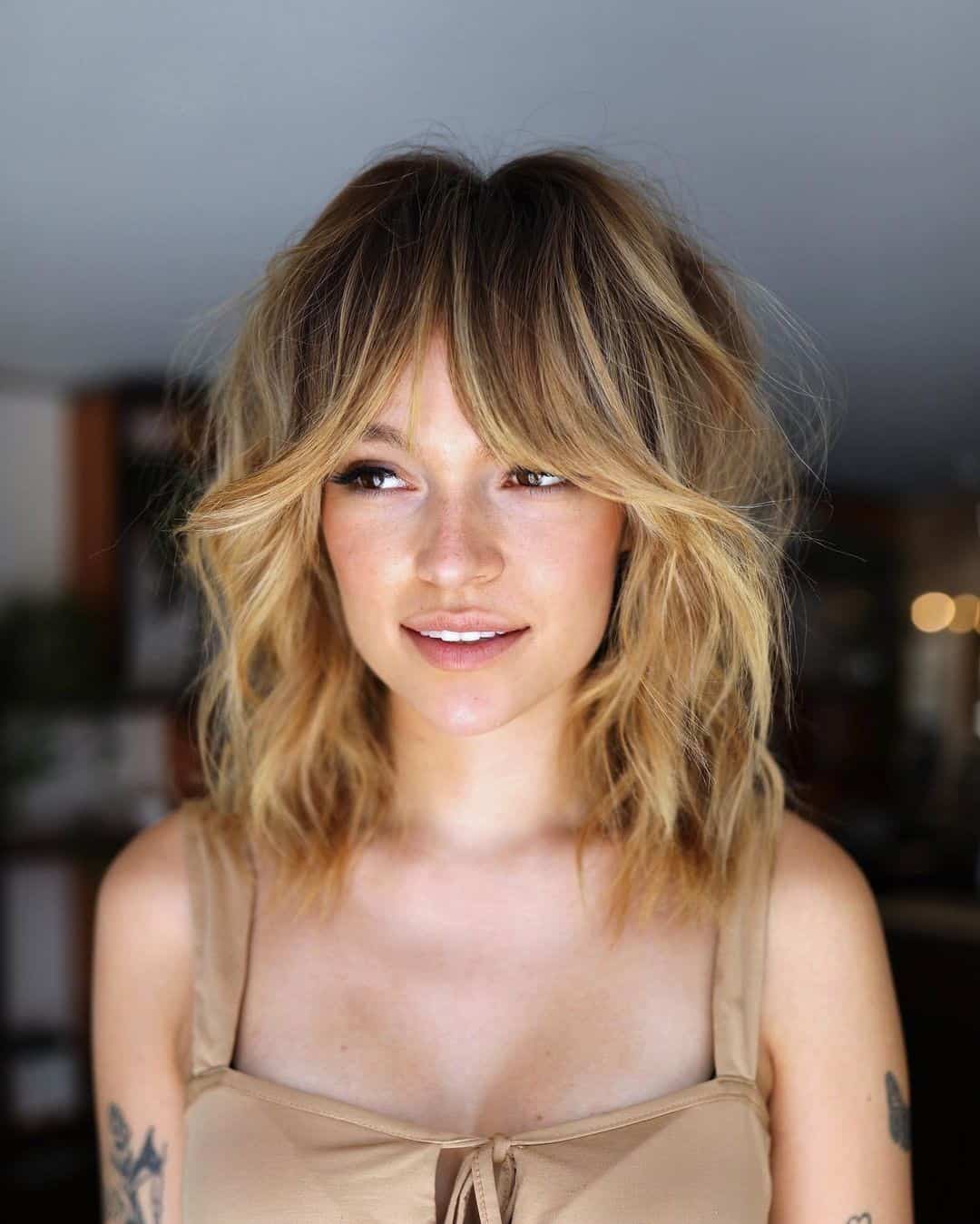 Wavy Bangs Voluminous Hair Look For A Round Face