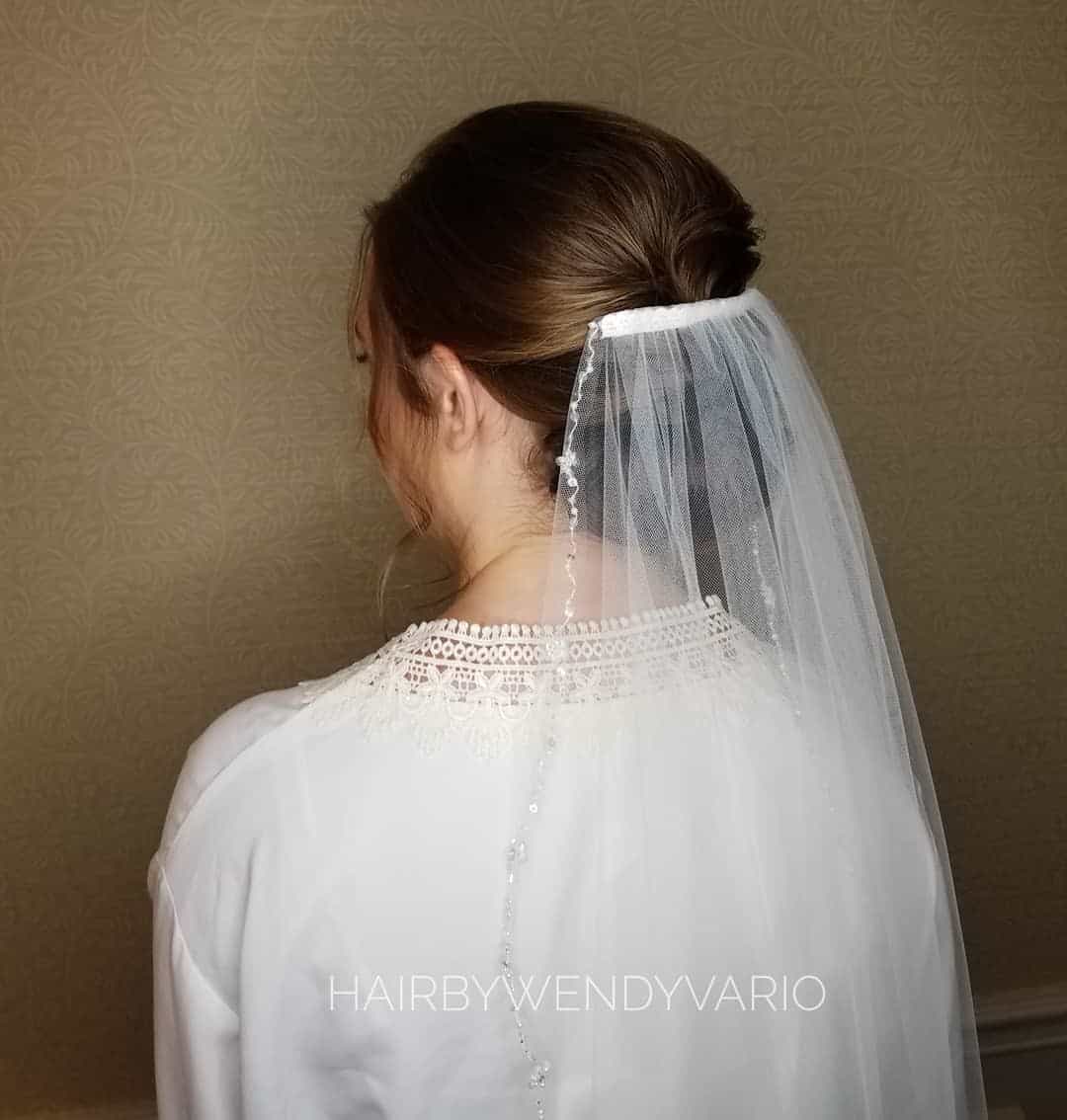 Low Brown Bun Wedding Hairstyle With Veil