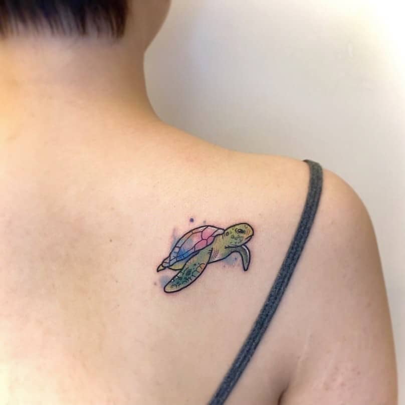Tiny Sea Turtle Tattoo Over Shoulder