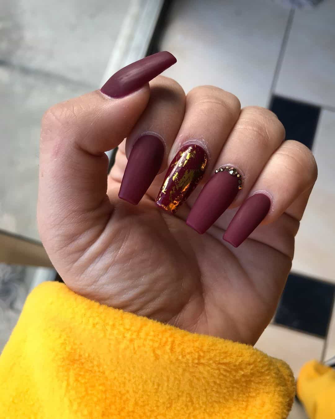 Long Burgundy Nails With Yellow Gold 