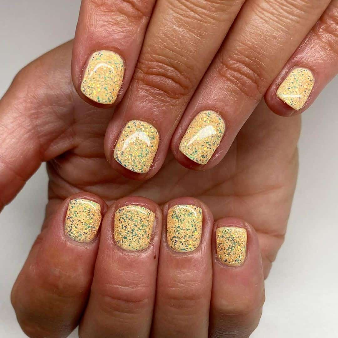Short Yellow Manicure With Glitter